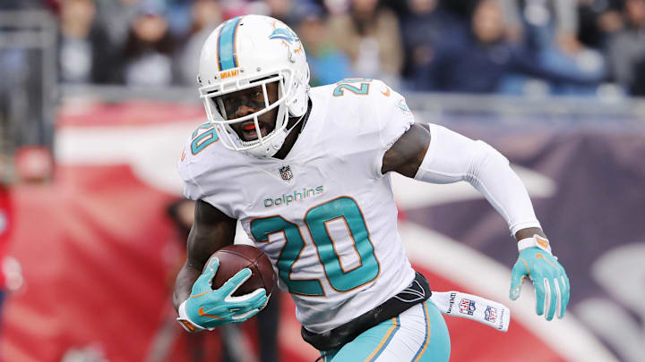 Miami Dolphins free safety Reshad Jones runs the ball back for a touchdown after recovering a fumble against the New England Patriots during the second quarter at Gillette Stadium in a 2017 game.