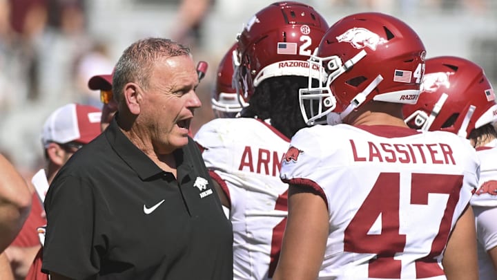 Arkansas Razorbacks coach Sam Pittman speaks as Maddox Lassiter listens during a timeout during the first quarter of the game against the Mississippi State Bulldogs at Davis Wade Stadium at Scott Field.