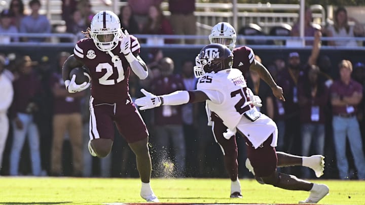 Oct 19, 2024; Starkville, Mississippi, USA; Mississippi State Bulldogs running back Davon Booth (21) runs the ball against Texas A&M Aggies defensive back Dalton Brooks (25) during the first quarter at Davis Wade Stadium at Scott Field. Mandatory Credit: Matt Bush-Imagn Images