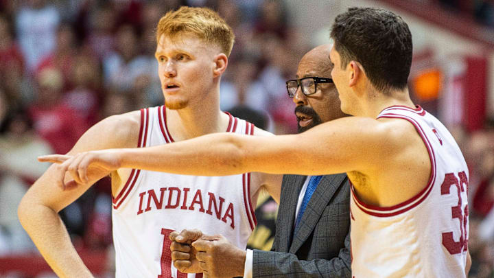 Indiana's Luke Goode (10) and Trey Galloway (32) talk with Coach Mike Woodson during the Indiana versus Purdue mens basketball game at Simon Skjodt Assembly Hall on Sunday, Feb. 23, 2025.