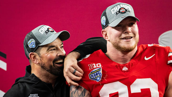 Ohio State Buckeyes head coach Ryan Day and defensive end Jack Sawyer (33) soak in the moment on stage while celebrating their win over the Texas Longhorns in the Cotton Bowl College Football Playoff semi-final.