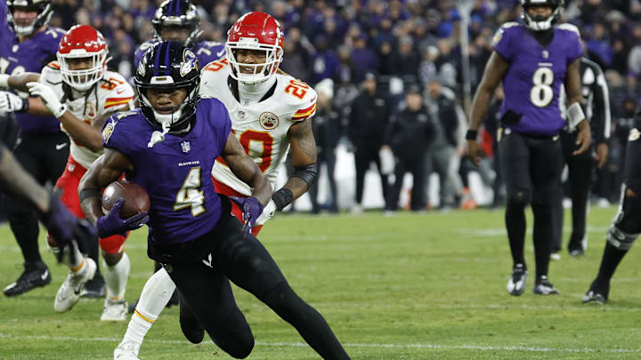 Jan 28, 2024; Baltimore, Maryland, USA; Baltimore Ravens wide receiver Zay Flowers (4) runs with the ball after making a catch prior to fumbling into the end zone as Kansas City Chiefs safety Justin Reid (20) chases in the AFC Championship football game at M&T Bank Stadium. Mandatory Credit: Geoff Burke-Imagn Images