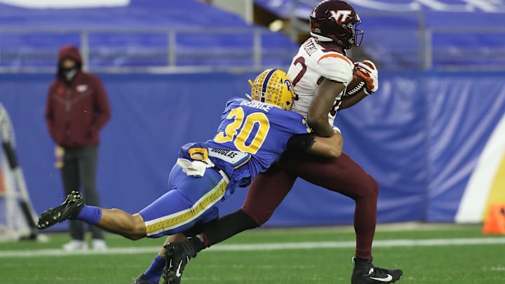 Nov 21, 2020; Pittsburgh, Pennsylvania, USA;  Virginia Tech Hokies tight end James Mitchell (82) runs after a catch as Pittsburgh Panthers linebacker Brandon George (30) tackles during the second quarter at Heinz Field. Mandatory Credit: Charles LeClaire-Imagn Images