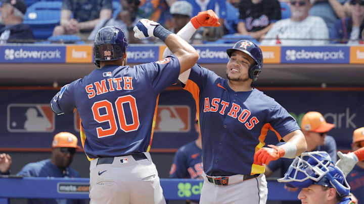 Mar 16, 2025; Port St. Lucie, Florida, USA;  Houston Astros catcher Yainer Diaz (21) and right fielder Cam Smith (90) celebrate after scoring on a two run home run during the second inning against the New York Mets at Clover Park. Mandatory Credit: Reinhold Matay-Imagn Images