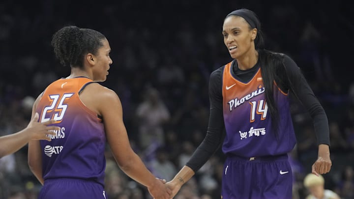 Phoenix Mercury forward Alyssa Thomas (25) slaps hands with Phoenix Mercury forward DeWanna Bonner (14).