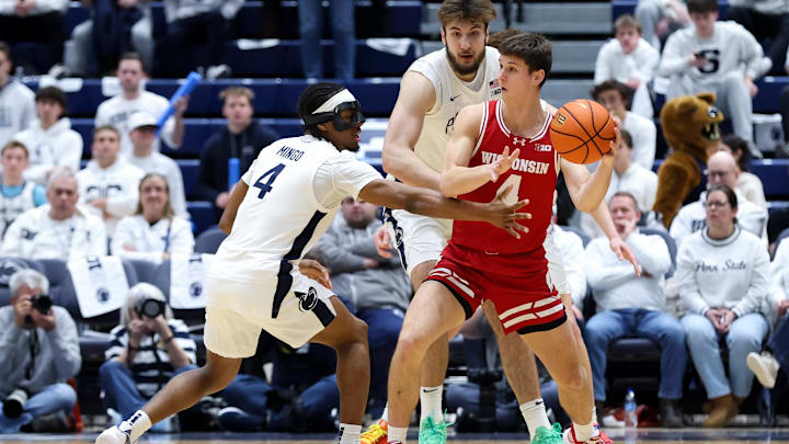 Jan 22, 2026; University Park, Pennsylvania, USA; Wisconsin Badgers guard Zach Kinziger (4) looks to pass the ball as Penn State Nittany Lions guard Kayden Mingo (4) and forward Ivan Juric (3) defend during the second half at Rec Hall. 
