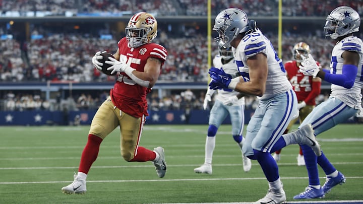 Jan 16, 2022; Arlington, Texas, USA; San Francisco 49ers running back Elijah Mitchell (25) runs for a touchdown.