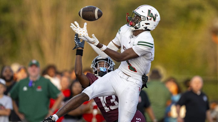 Lawrence North High School sophomore Monshun Sales (1) makes a catch in the end zone to score while being defended by Lawrence Central High School junior DJ Summers (13) during the first half of an IHSAA varsity football game, Friday, Aug. 23, 2024, at Lawrence Central High School.