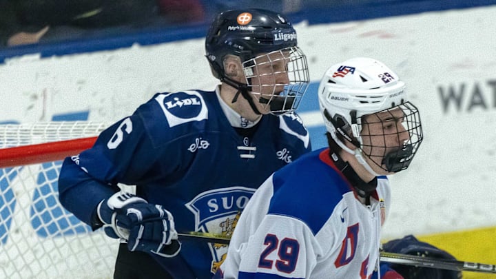 Feb 7, 2024; Plymouth, MI, USA; Finland's Niilopekka Muhonen (6) defends against USA s Shane Vansaghi (29) during the first period of the 2024 U18 s Five Nations Tournament at USA Hockey Arena. Mandatory Credit: David Reginek-Imagn Images