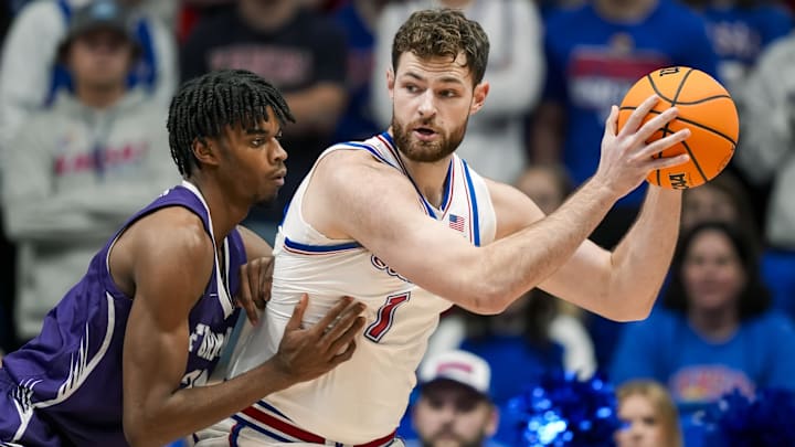 Nov 30, 2024; Lawrence, Kansas, USA; Kansas Jayhawks center Hunter Dickinson (1) looks to pass against Furman Paladins forward Cooper Bowser (21) during the first half at Allen Fieldhouse. Mandatory Credit: Jay Biggerstaff-Imagn Images Nov 30, 2024; Lawrence, Kansas, USA; Kansas Jayhawks center Hunter Dickinson (1) looks to pass against Furman Paladins forward Cooper Bowser (21) during the first half at Allen Fieldhouse. Mandatory Credit: Jay Biggerstaff-Imagn Images