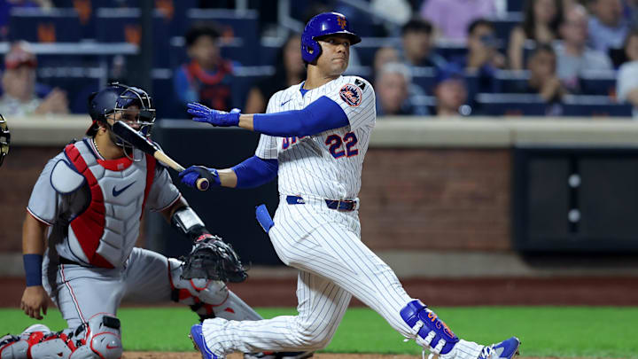 Jun 10, 2025; New York City, New York, USA; New York Mets right fielder Juan Soto (22) follows through on an RBI double against the Washington Nationals during the eighth inning at Citi Field. Mandatory Credit: Brad Penner-Imagn Images