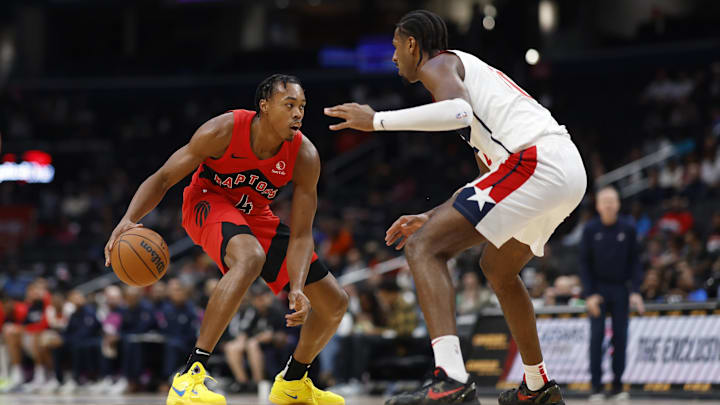 Oct 11, 2024; Washington, District of Columbia, USA; Toronto Raptors forward Scottie Barnes (4) dribbles the ball as Washington Wizards forward Alex Sarr (20) defends in the second quarter at Capital One Arena. Mandatory Credit: Geoff Burke-Imagn Images
