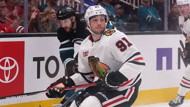 Apr 6, 2026; San Jose, California, USA;  Chicago Blackhawks center Frank Nazar (91) and San Jose Sharks defenseman Vincent Desharnais (5) chase the puck in the first period at SAP Center at San Jose. Mandatory Credit: David Gonzales-Imagn Images