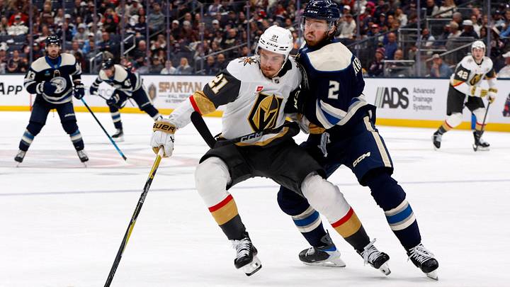 Columbus Blue Jackets defenseman Jake Christiansen (2) checks Vegas Golden Knights center Brett Howden (21) during the third period at Nationwide Arena.  Mandatory Credit: Russell LaBounty-Imagn Images