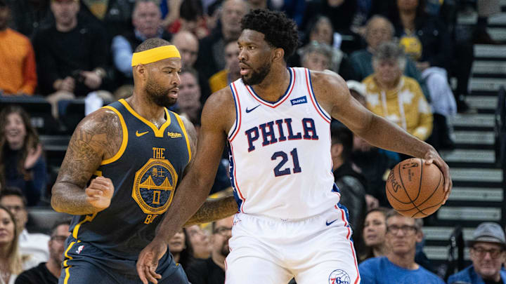 January 31, 2019; Oakland, CA, USA; Philadelphia 76ers center Joel Embiid (21) dribbles the basketball against Golden State Warriors center DeMarcus Cousins (0) during the third quarter at Oracle Arena. The 76ers defeated the Warriors 113-104. Mandatory Credit: Kyle Terada-Imagn Images