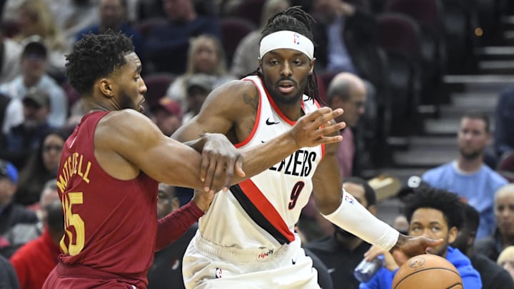 Nov 30, 2023; Cleveland, Ohio, USA: Portland Trail Blazers forward Jerami Grant (9) drives against Cleveland Cavaliers guard Donovan Mitchell (45) in the second quarter at Rocket Mortgage FieldHouse. Mandatory Credit: David Richard-Imagn Images