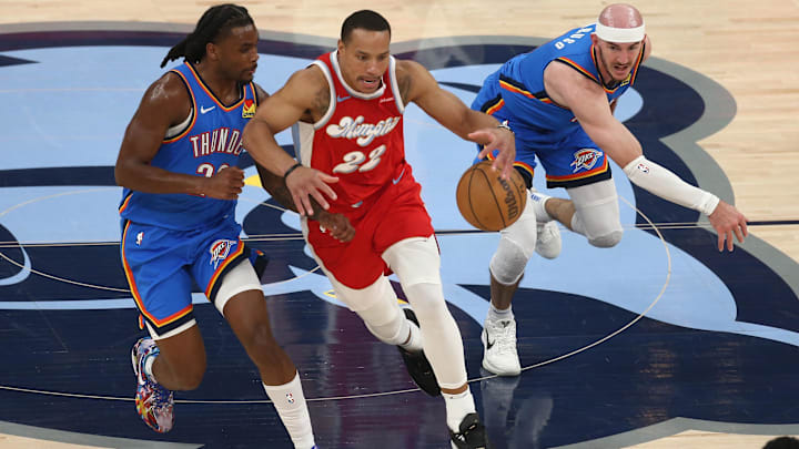 Apr 26, 2025; Memphis, Tennessee, USA; Memphis Grizzlies guard Desmond Bane (22) dribbles as Oklahoma City Thunder guard Cason Wallace (22) and guard Alex Caruso (9) defend during the second quarter during game four for the first round of the 2024 NBA Playoffs at FedExForum. Mandatory Credit: Petre Thomas-Imagn Images