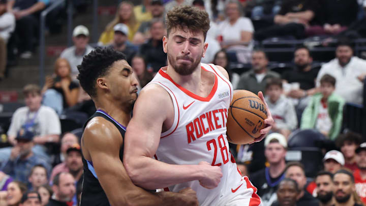 Mar 27, 2025; Salt Lake City, Utah, USA; Houston Rockets center Alperen Sengun (28) drives into Utah Jazz forward KJ Martin (left) during the second half at Delta Center. Mandatory Credit: Rob Gray-Imagn Images