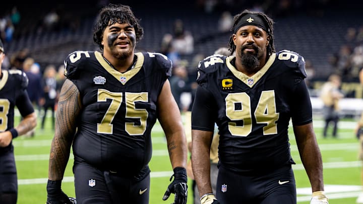 Sep 8, 2024; New Orleans, Louisiana, USA; New Orleans Saints offensive tackle Taliese Fuaga (75) and defensive end Cameron Jordan (94) head to the locker room after the game against the Carolina Panthers at Caesars Superdome. Mandatory Credit: Stephen Lew-Imagn Images Sep 8, 2024; New Orleans, Louisiana, USA; New Orleans Saints offensive tackle Taliese Fuaga (75) and defensive end Cameron Jordan (94) head to the locker room after the game against the Carolina Panthers at Caesars Superdome. Mandatory Credit: Stephen Lew-Imagn Images