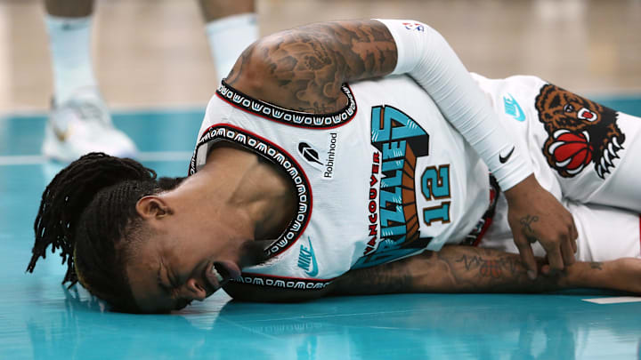 Apr 24, 2025; Memphis, Tennessee, USA; Memphis Grizzlies guard Ja Morant (12) lays on the court after being fouled during the second quarter against the Oklahoma City Thunder during game three for the first round of the 2024 NBA Playoffs at FedExForum. Mandatory Credit: Petre Thomas-Imagn Images Apr 24, 2025; Memphis, Tennessee, USA; Memphis Grizzlies guard Ja Morant (12) lays on the court after being fouled during the second quarter against the Oklahoma City Thunder during game three for the first round of the 2024 NBA Playoffs at FedExForum. Mandatory Credit: Petre Thomas-Imagn Images