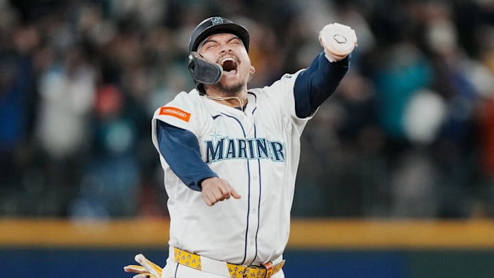 Oct 17, 2025; Seattle, Washington, USA; Seattle Mariners first baseman Josh Naylor (12) reacts after third baseman Eugenio Suarez (not pictured) hits a grand slam against the Toronto Blue Jays in the eighth inning during game five of the ALCS round for the 2025 MLB playoffs at T-Mobile Park. Mandatory Credit: Stephen Brashear-Imagn Images