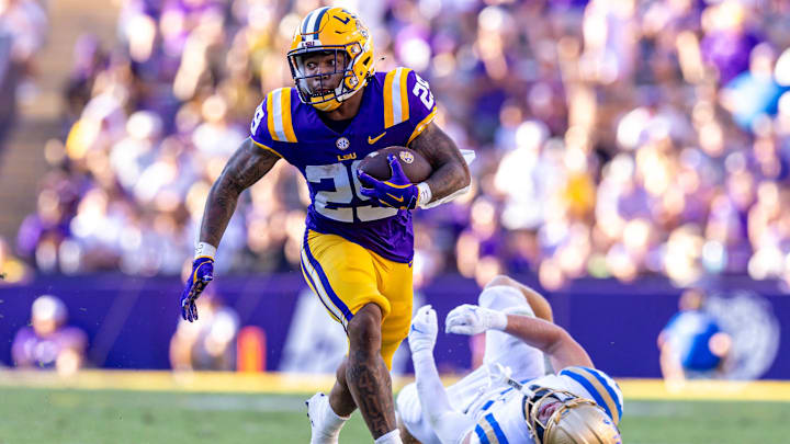 Sep 21, 2024; Baton Rouge, Louisiana, USA; UCLA Bruins linebacker Carson Schwesinger (49) misses a tackle against LSU Tigers running back Caden Durham (29) during the second half at Tiger Stadium. Mandatory Credit: Stephen Lew-Imagn Images Sep 21, 2024; Baton Rouge, Louisiana, USA; UCLA Bruins linebacker Carson Schwesinger (49) misses a tackle against LSU Tigers running back Caden Durham (29) during the second half at Tiger Stadium. Mandatory Credit: Stephen Lew-Imagn Images