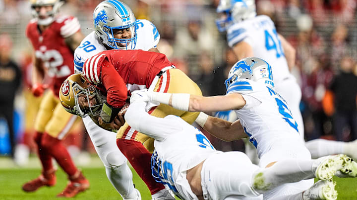 Detroit Lions defensive tackle Chris Smith (90) and defensive end Za'Darius Smith (99) tackle San Francisco 49ers quarterback Brock Purdy (13) during the first half at Levi's Stadium in Santa Clara, Calif. on Monday, Dec. 30, 2024.