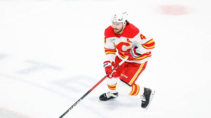 Jan 15, 2026; Chicago, Illinois, USA; Calgary Flames defenseman Rasmus Andersson (4) controls the puck against the Chicago Blackhawks during the second period at United Center. Mandatory Credit: Kamil Krzaczynski-Imagn Images