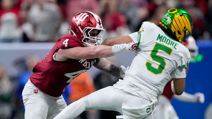 Indiana Hoosiers linebacker Aiden Fisher pushes Oregon Ducks quarterback Dante Moore to the ground in the Peach Bowl.