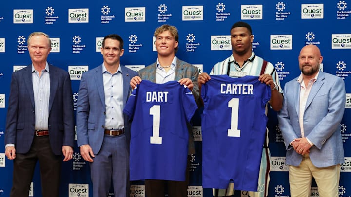 Apr 25, 2025; East Rutherford, NJ, US; New York Giants president John Mara (far left), general manager Joe Schoen (left), Jaxson Dart, Abdul Carter, and head coach Brian Daboll (right) pose for photos before the start of the press conference to introduce the Giants first round draft picks. Apr 25, 2025; East Rutherford, NJ, US; New York Giants president John Mara (far left), general manager Joe Schoen (left), Jaxson Dart, Abdul Carter, and head coach Brian Daboll (right) pose for photos before the start of the press conference to introduce the Giants first round draft picks.