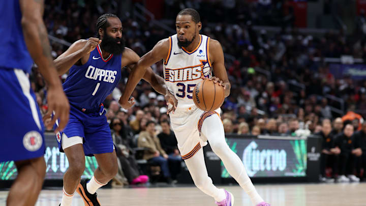Phoenix Suns forward Kevin Durant (35) dribbles the ball against Los Angeles Clippers guard James Harden (1) during the fourth quarter at Crypto.com Arena. Mandatory Credit: Kiyoshi Mio-Imagn Images