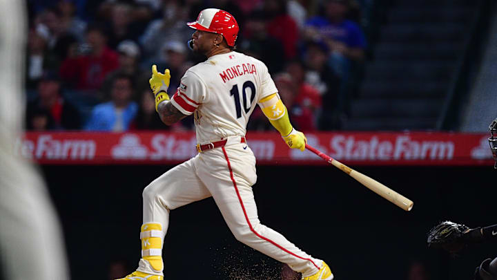 Apr 21, 2026; Anaheim, California, USA; Los Angeles Angels third baseman Yoan Moncada (10) hits an RBI single against the Toronto Blue Jays during the ninth inning at Angel Stadium. Mandatory Credit: Gary A. Vasquez-Imagn Images