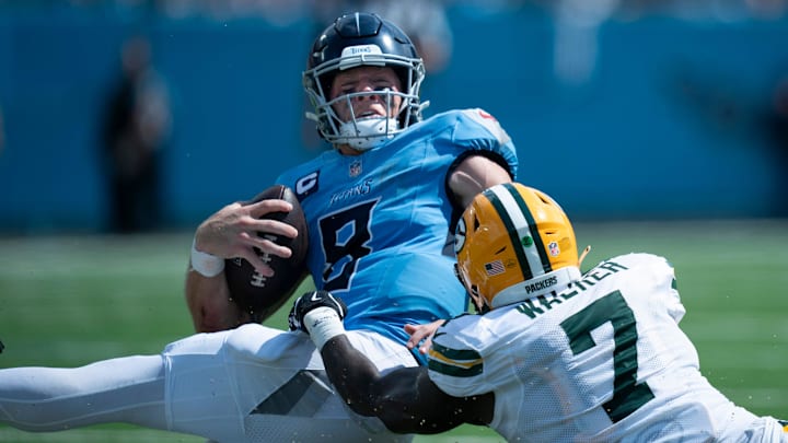 Green Bay Packers linebacker Quay Walker (7) tackles Tennessee Titans quarterback Will Levis (8) short of the first down on a fourth-down play in the third quarter during their game at Nissan Stadium in Nashville, Tenn., Sunday, Sept. 22, 2024.