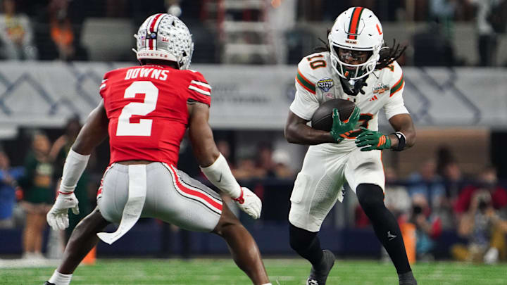 Dec 31, 2025; Arlington, TX, USA; Miami Hurricanes linebacker Raul Aguirre Jr. (10) moves with the ball while defended by Ohio State Buckeyes safety Caleb Downs (2) in the first quarter during the 2025 Cotton Bowl and quarterfinal game of the College Football Playoff at AT&T Stadium. Mandatory Credit: Raymond Carlin III-Imagn Images