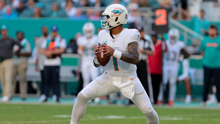 Nov 24, 2024; Miami Gardens, Florida, USA; Miami Dolphins quarterback Tua Tagovailoa (1) looks for a passing option against the New England Patriots during the fourth quarter at Hard Rock Stadium. Mandatory Credit: Sam Navarro-Imagn Images