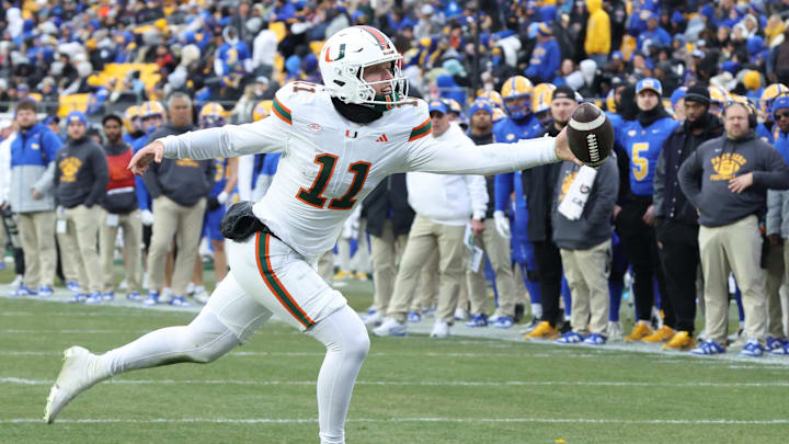 Nov 29, 2025; Pittsburgh, Pennsylvania, USA; Miami Hurricanes quarterback Carson Beck (11) reaches for an errant pass on a trick play against the Pittsburgh Panthers during the third quarter at Acrisure Stadium. Mandatory Credit: Charles LeClaire-Imagn Images Nov 29, 2025; Pittsburgh, Pennsylvania, USA; Miami Hurricanes quarterback Carson Beck (11) reaches for an errant pass on a trick play against the Pittsburgh Panthers during the third quarter at Acrisure Stadium. Mandatory Credit: Charles LeClaire-Imagn Images