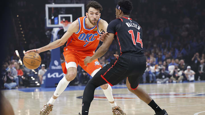 Jan 25, 2026; Oklahoma City, Oklahoma, USA;  Oklahoma City Thunder center/forward Chet Holmgren (7) moves the ball down the court as Toronto Raptors guard Ja'kobe Walter (14) defends during the first quarter at Paycom Center. Mandatory Credit: Alonzo Adams-Imagn Images