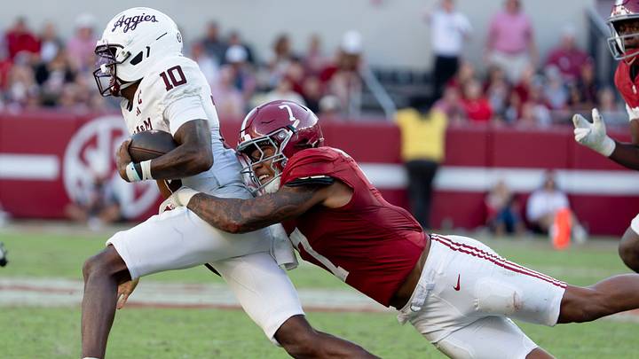 Oct 24, 2026; Tuscaloosa, AL, USA;  Texas A&M quarterback Marcel Reed (10) is tackled behind the line of scrimmage on a running play by Alabama linebacker Caleb Woodson (7) at Saban Field at Bryant Denny Stadium. Alabama defeated Texas A&M 31-20. Mandatory Credit: Gary Cosby Jr.-Tuscaloosa News