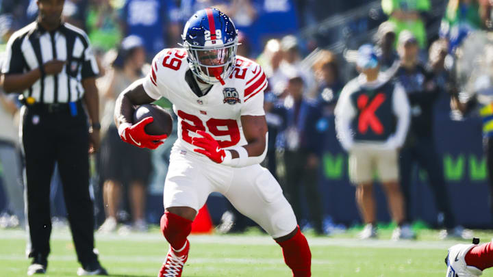 Oct 6, 2024; Seattle, Washington, USA; New York Giants running back Tyrone Tracy Jr. (29) rushes against the Seattle Seahawks during the first quarter at Lumen Field. Mandatory Credit: Joe Nicholson-Imagn Images