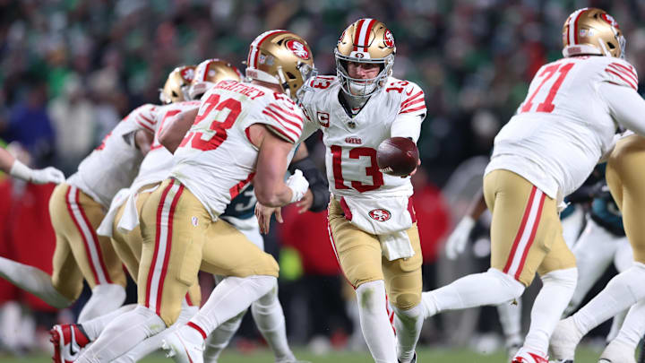 Jan 11, 2026; Philadelphia, PA, USA; San Francisco 49ers quarterback Brock Purdy (13) hands off the ball to running back Christian McCaffrey (23) against the Philadelphia Eagles during the second quarter in an NFC Wild Card Round game at Lincoln Financial Field. Mandatory Credit: Bill Streicher-Imagn Images