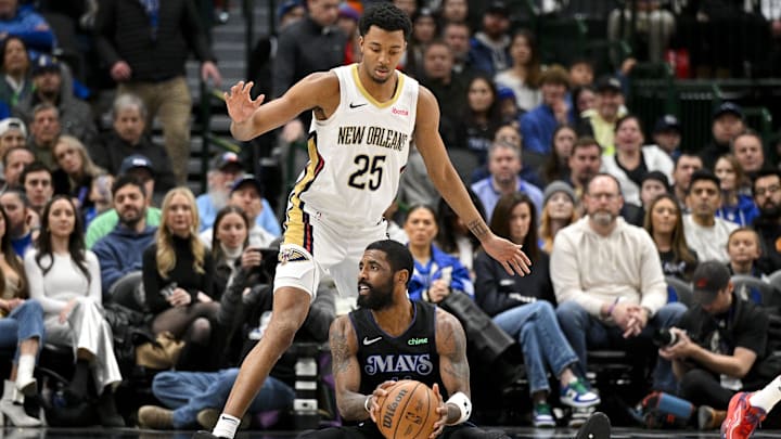 Jan 15, 2024; Dallas, Texas, USA; Dallas Mavericks guard Kyrie Irving (11) looks to pass the ball in front of New Orleans Pelicans guard Trey Murphy III (25) during the second half at the American Airlines Center. Mandatory Credit: Jerome Miron-Imagn Images