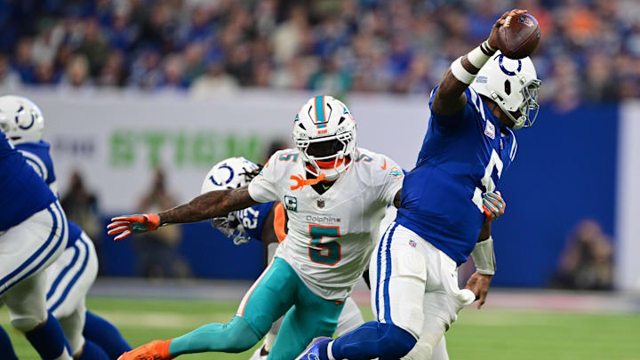 Oct 20, 2024; Indianapolis, Indiana, USA; Miami Dolphins cornerback Jalen Ramsey (5) gets a hand on Indianapolis Colts quarterback Anthony Richardson (5) during the second quarter at Lucas Oil Stadium. Mandatory Credit: Marc Lebryk-Imagn Images