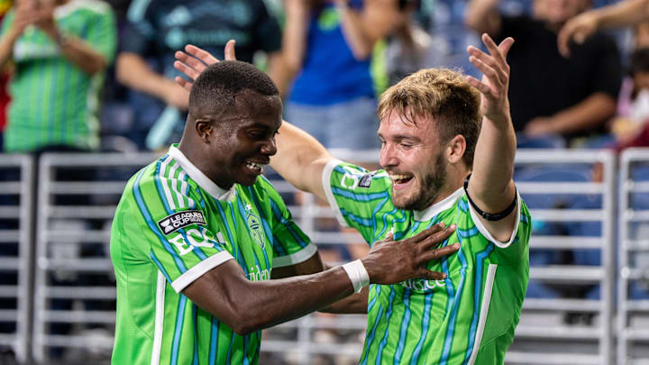 Jul 31, 2025; Seattle, Washington, USA;  Seattle Sounders forward Pedro de la Vega (10), right, celebrates with defender Nouhou Tolo (5) after scoring a goal during the second half against Cruz Azul at Lumen Field. Mandatory Credit: Stephen Brashear-Imagn Images