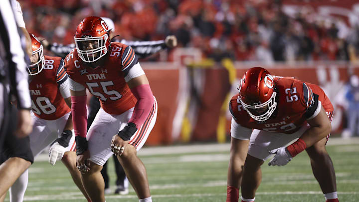 Utah Utes offensive lineman Spencer Fano (55) and Utah Utes offensive lineman Michael Mokofisi (52) wait for the play during a game at Rice-Eccles Stadium.