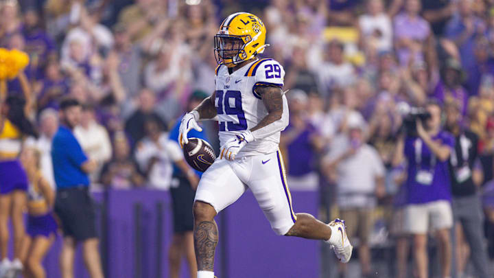 Sep 28, 2024; Baton Rouge, Louisiana, USA;  LSU Tigers running back Caden Durham (29) runs in a 71-yard touchdown pass from quarterback Garrett Nussmeier (not pictured) against South Alabama Jaguars safety Jaden Voisin (2) during the first quarter at Tiger Stadium. Mandatory Credit: Stephen Lew-Imagn Images
