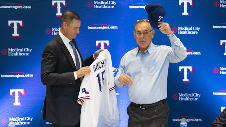 Texas Rangers general manager Chris Young presents new team manager Bruce Bochy his Rangers jersey and cap during a news conference at Globe Life Field. 