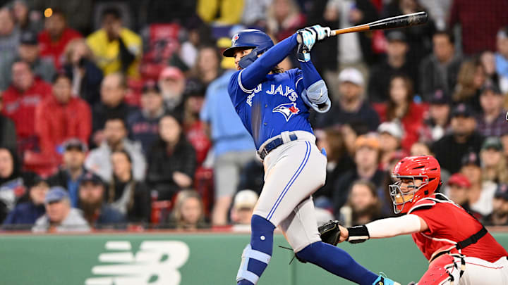 Toronto Blue Jays shortstop Bo Bichette hits a home run at Fenway Park, wearing a blue jersey and a matching helmet. Toronto Blue Jays shortstop Bo Bichette hits a home run at Fenway Park, wearing a blue jersey and a matching helmet.
