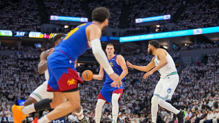 May 16, 2024; Minneapolis, Minnesota, USA; Denver Nuggets center Nikola Jokic (15) looks to pass to guard Jamal Murray (27) against the Minnesota Timberwolves in the second quarter during game six of the second round for the 2024 NBA playoffs at Target Center. Mandatory Credit: Brad Rempel-USA TODAY Sports