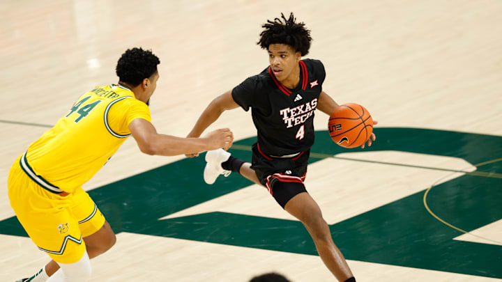 Texas Tech Red Raiders guard Christian Anderson (4) controls the ball as Baylor Bears center Caden Powell (44) defends during the first half at Paul and Alejandra Foster Pavilion.