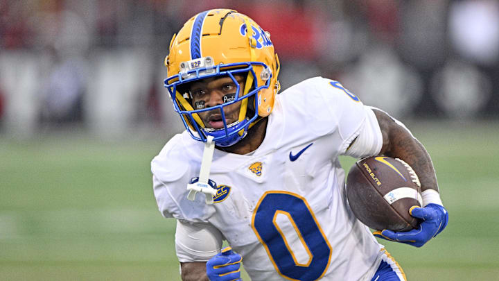 Nov 23, 2024; Louisville, Kentucky, USA;  Pittsburgh Panthers running back Desmond Reid (0) runs against the Louisville Cardinals during the first quarter at L&N Federal Credit Union Stadium. Mandatory Credit: Jamie Rhodes-Imagn Images